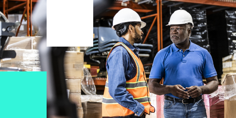 two man are discussion at construction site. 