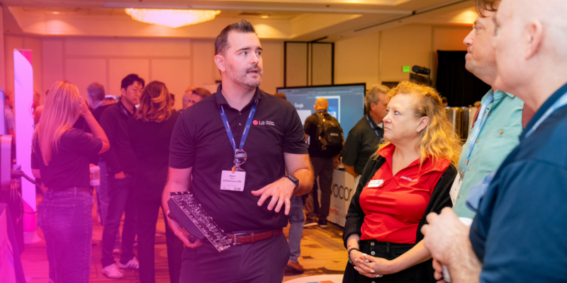 Broadway Lounge with modern seating, large digital screen, and people socializing.